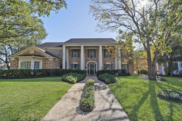 neoclassical home with a front lawn