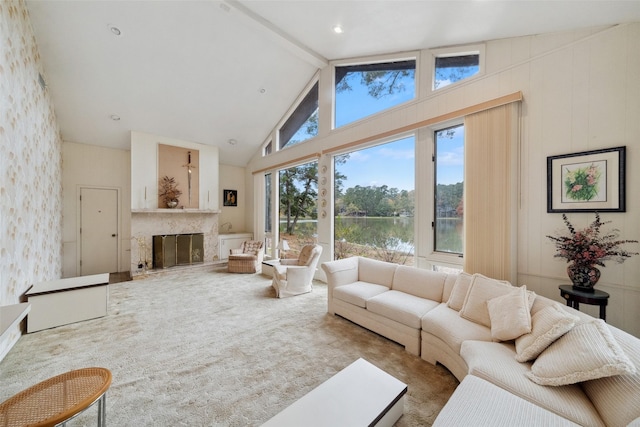 living room with high vaulted ceiling, beamed ceiling, carpet floors, and a water view