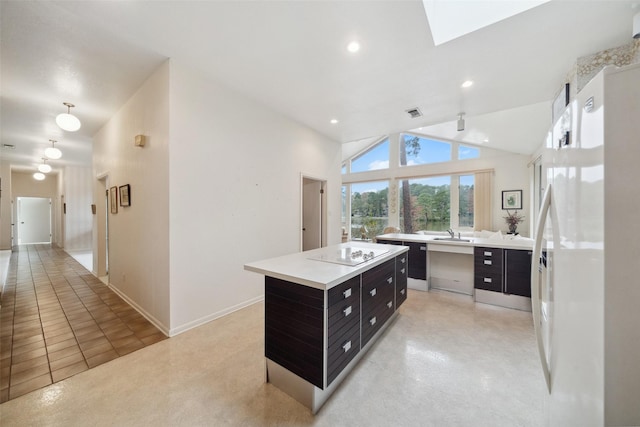 kitchen featuring a kitchen island, white fridge, sink, light tile patterned flooring, and black electric cooktop