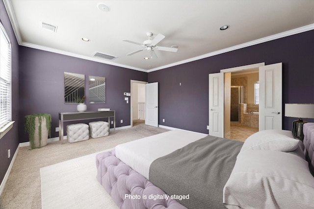 carpeted bedroom featuring ceiling fan, multiple windows, ensuite bathroom, and crown molding