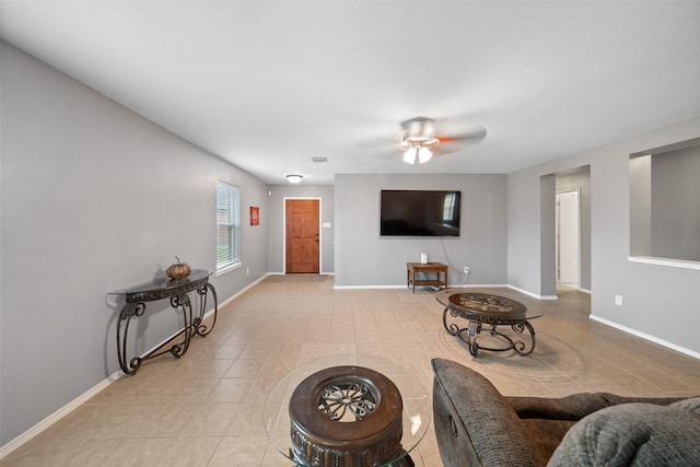 tiled living room with ceiling fan