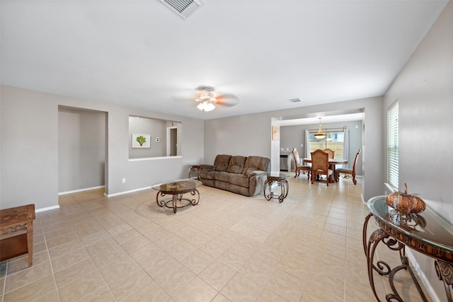 tiled living room with ceiling fan