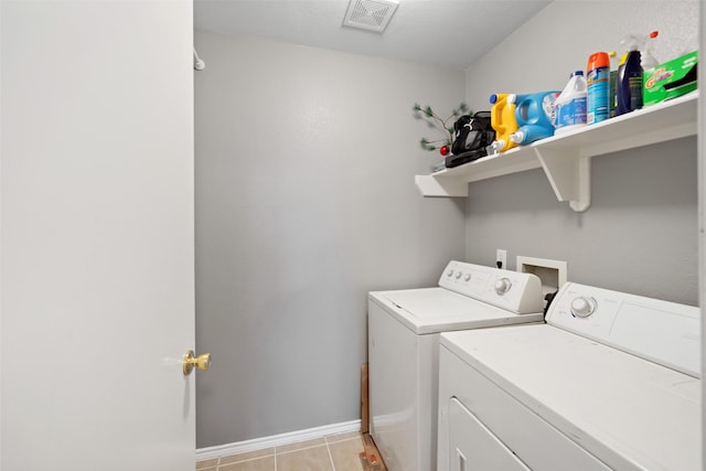 washroom with washer and dryer and light tile patterned floors