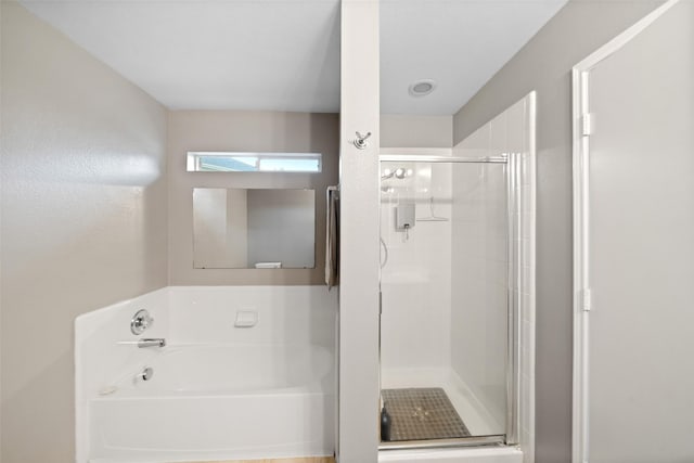 bathroom featuring separate shower and tub