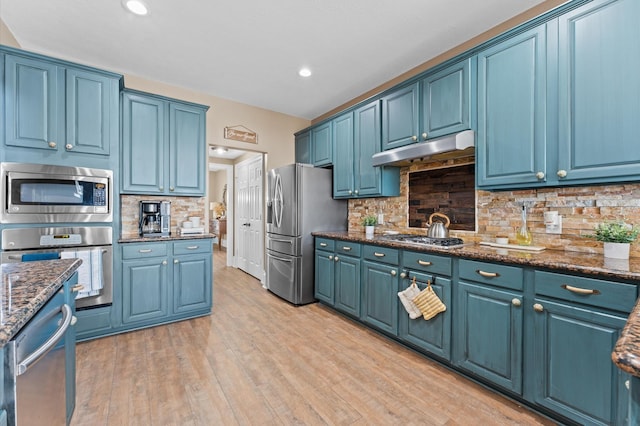 kitchen featuring stainless steel appliances and blue cabinets