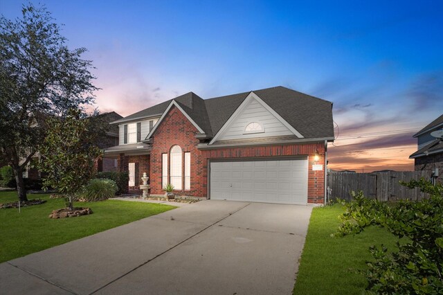 view of front facade with a garage and a lawn