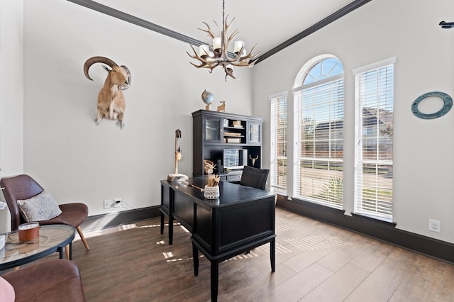 home office with ornamental molding, a chandelier, and hardwood / wood-style floors