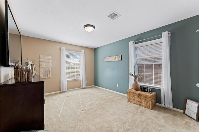 bedroom featuring light carpet