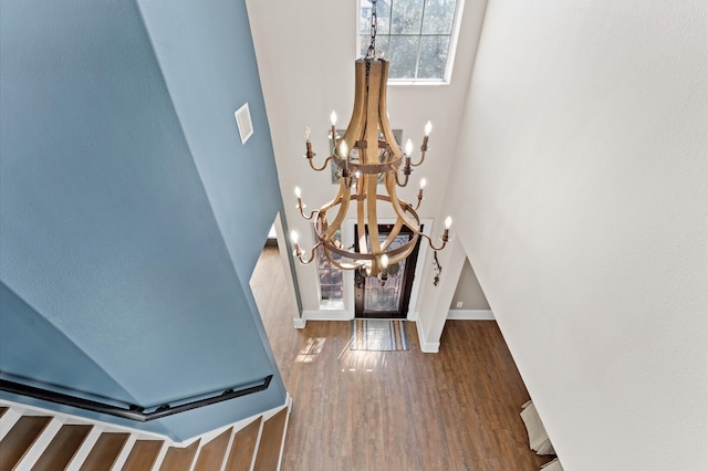 foyer entrance with dark wood-type flooring and an inviting chandelier