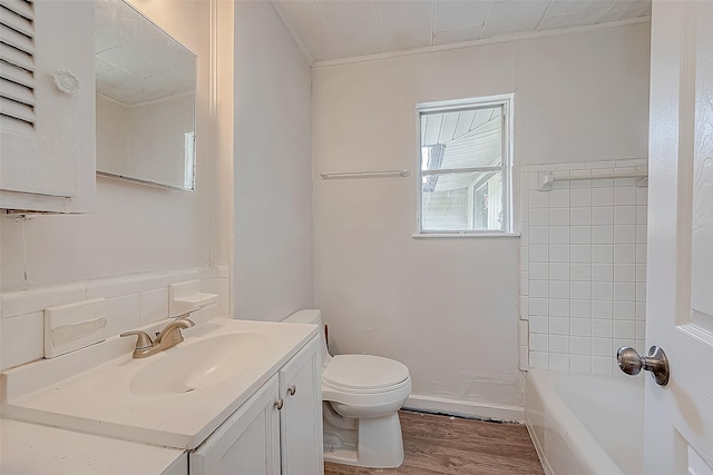 bathroom with vanity, toilet, wood-type flooring, and crown molding