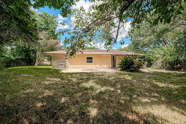 rear view of property featuring a yard