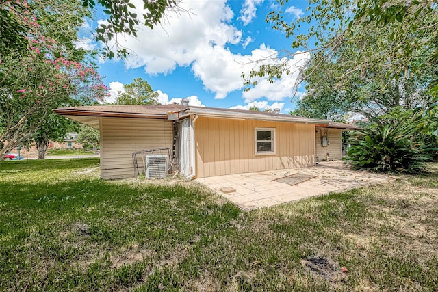 rear view of house with a yard and a patio