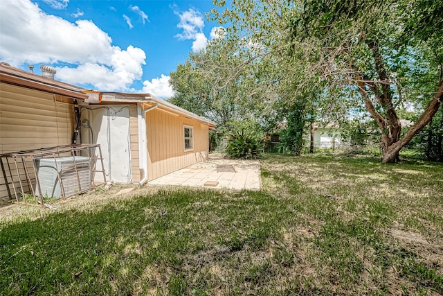 view of yard with central AC and a patio area