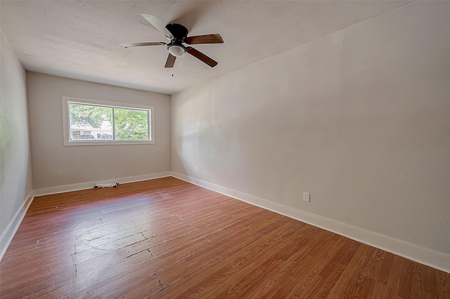 empty room featuring hardwood / wood-style floors and ceiling fan