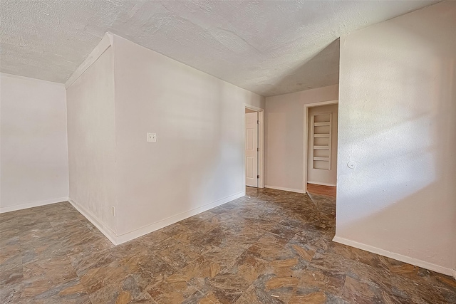 empty room with a textured ceiling