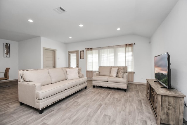 living room with light hardwood / wood-style flooring and lofted ceiling