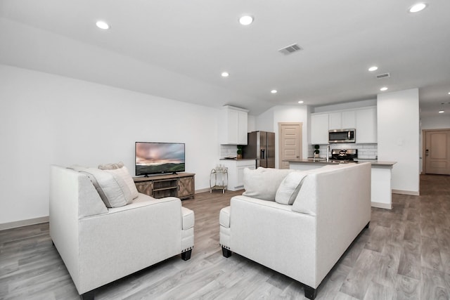 living room with light hardwood / wood-style floors