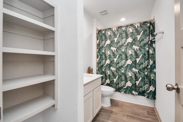 full bathroom featuring wood-type flooring, vanity, toilet, and shower / bath combo with shower curtain