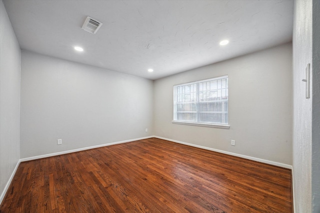 unfurnished room with dark hardwood / wood-style flooring