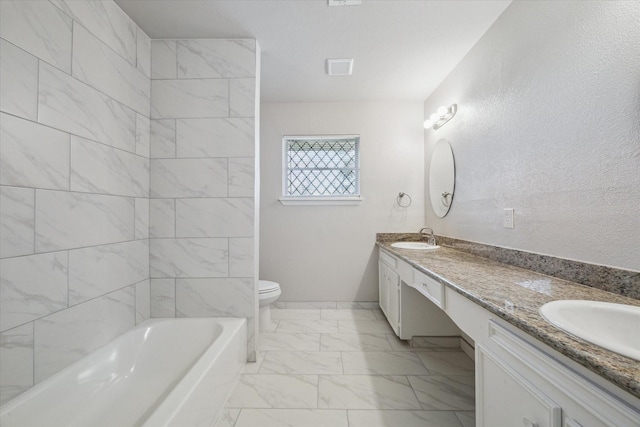 bathroom with a bath, vanity, and toilet