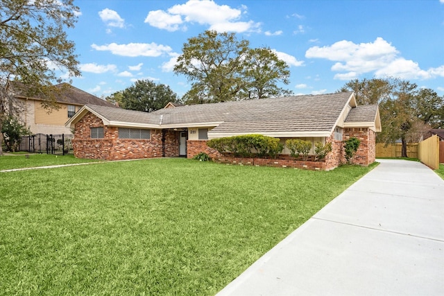 ranch-style home with a front lawn