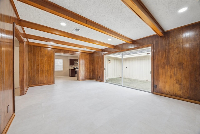 interior space featuring wood walls and a textured ceiling