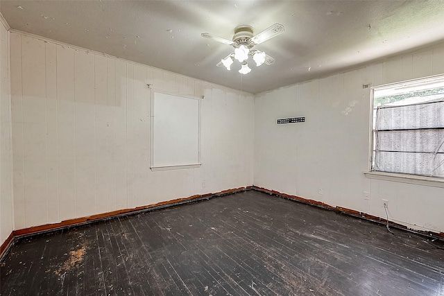 unfurnished room featuring ceiling fan and dark hardwood / wood-style floors