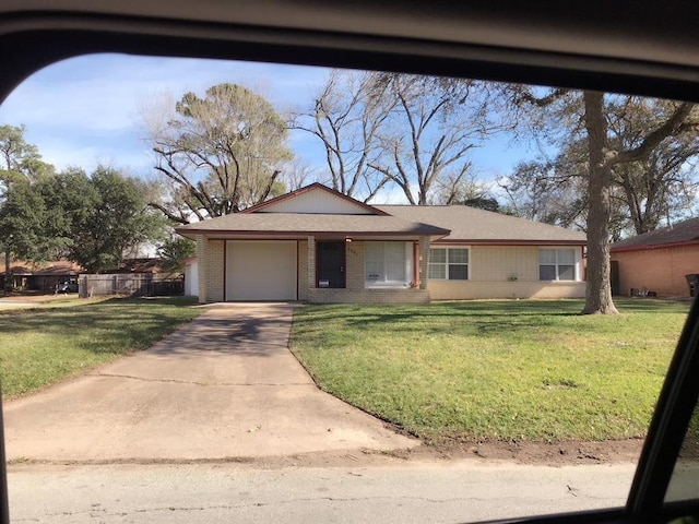 single story home with a front yard and a garage