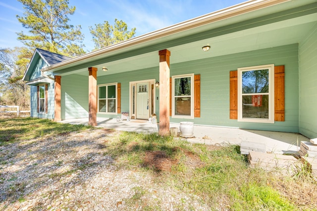 back of house featuring a porch