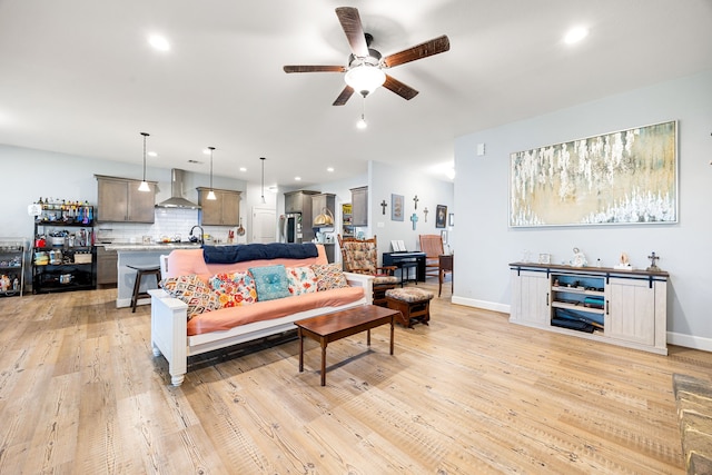 living area featuring recessed lighting, light wood-type flooring, and ceiling fan