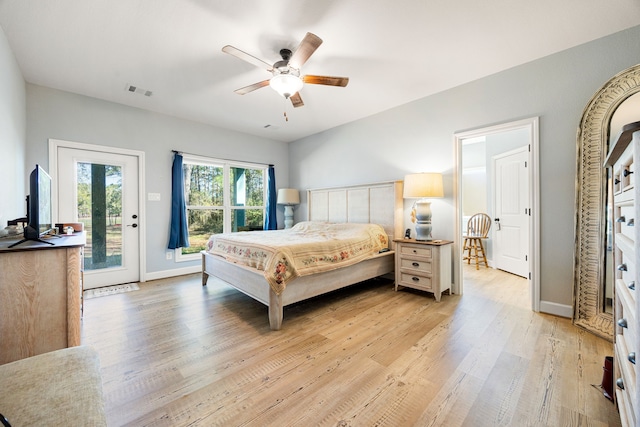 bedroom with access to outside, visible vents, light wood-type flooring, and baseboards