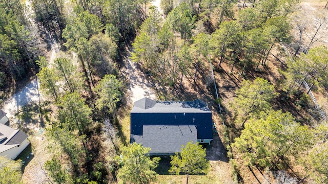 birds eye view of property with a view of trees