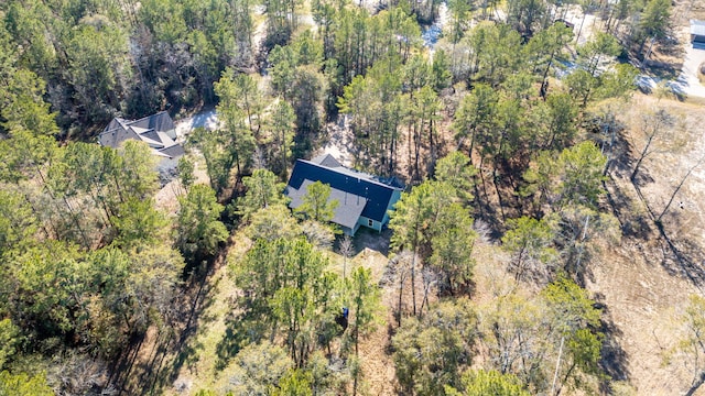 birds eye view of property featuring a view of trees