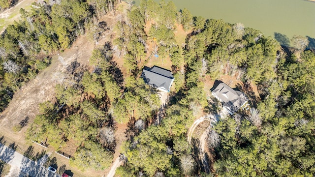 drone / aerial view with a wooded view