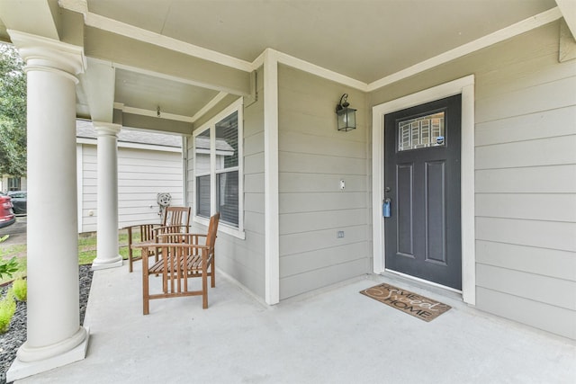 view of exterior entry with covered porch