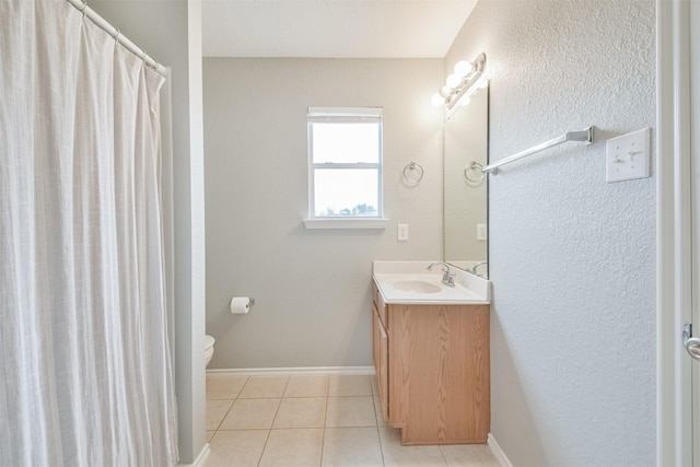 bathroom with tile patterned floors, vanity, and toilet