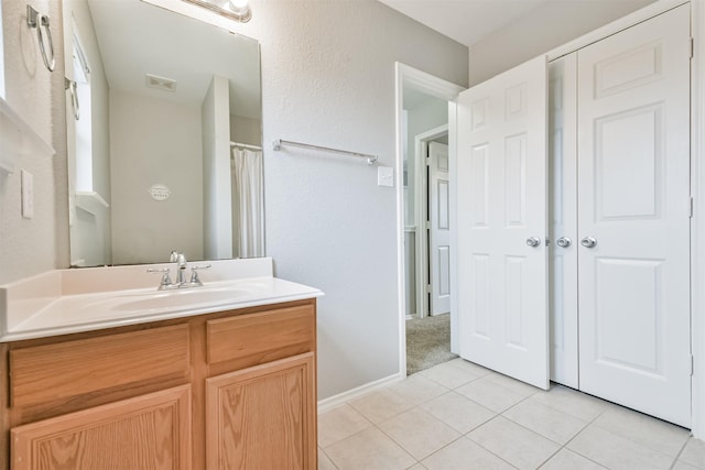 bathroom featuring tile patterned floors and vanity