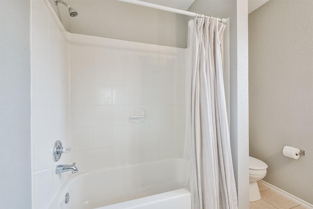 bathroom with tile patterned floors, toilet, and shower / bath combo with shower curtain