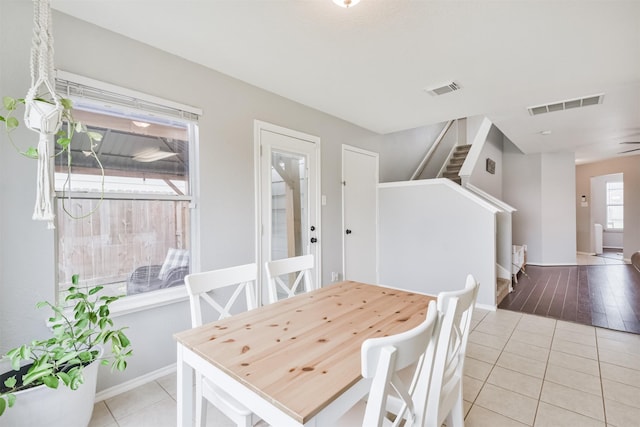 tiled dining room with ceiling fan