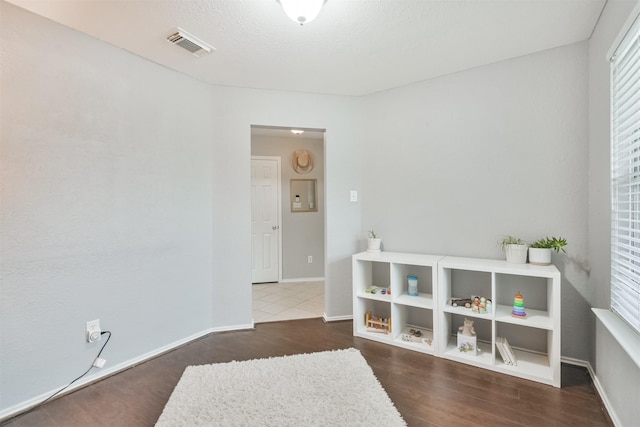 playroom with dark hardwood / wood-style floors