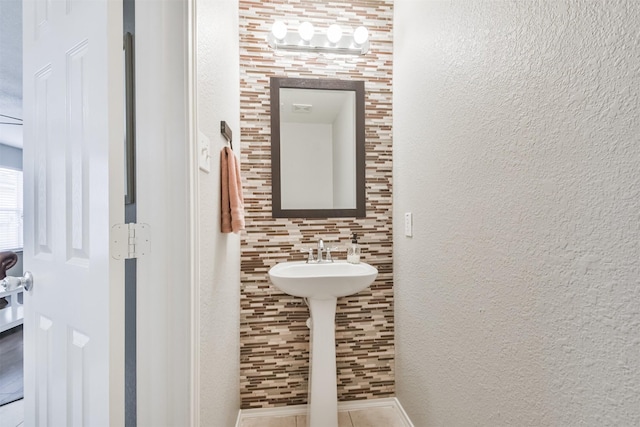 bathroom featuring tasteful backsplash