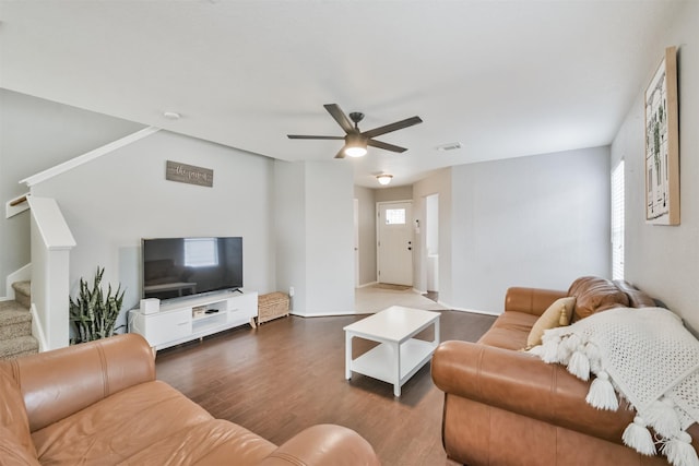 living room with dark hardwood / wood-style floors and ceiling fan