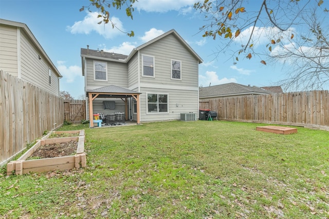 rear view of house with a gazebo, central AC unit, and a lawn