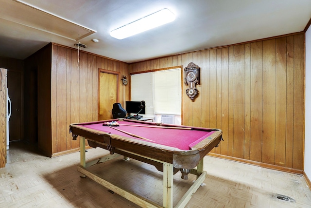 rec room with wood walls, light parquet floors, and pool table