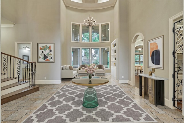 foyer entrance with a notable chandelier and a high ceiling