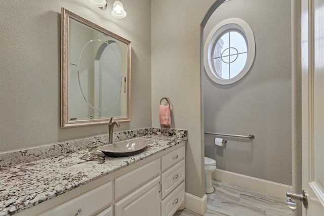 bathroom featuring vanity and toilet