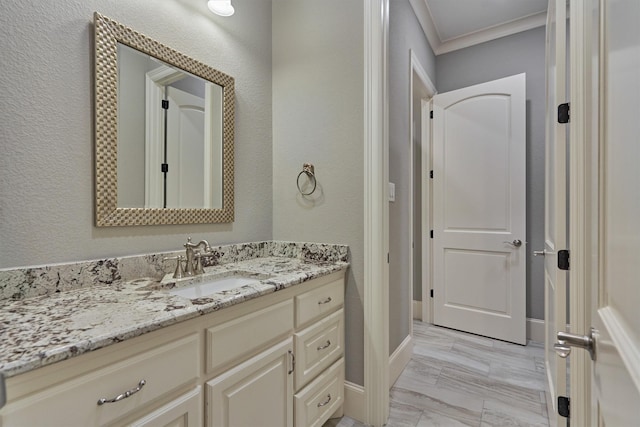 bathroom with vanity and crown molding