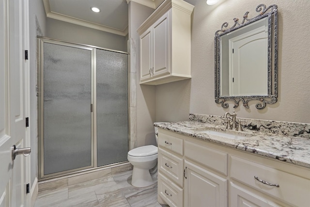 bathroom with toilet, vanity, ornamental molding, and walk in shower