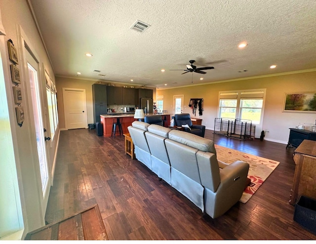 living room featuring a textured ceiling, dark hardwood / wood-style flooring, ceiling fan, and ornamental molding