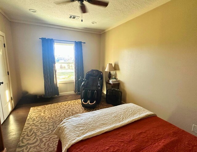 bedroom featuring ceiling fan, dark hardwood / wood-style flooring, and a textured ceiling